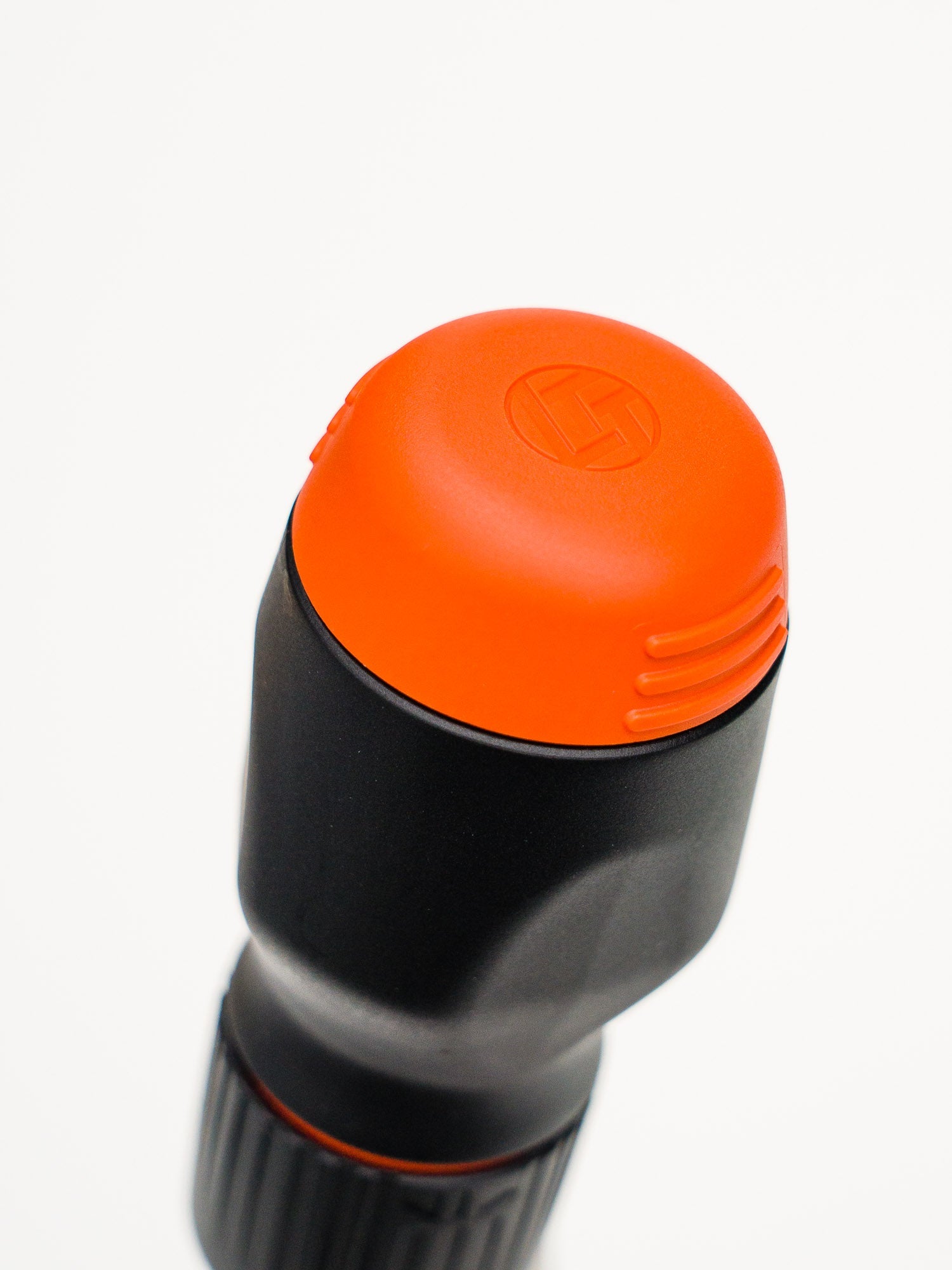 Top of handle of the black and orange stubby screw driver with LTT logo